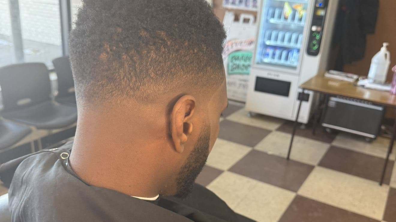 Rear view of a skin fade and beard lineup